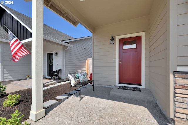 view of exterior entry featuring a porch