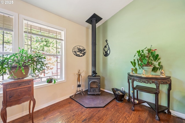 1274 Wild Mustang Ln, Gilchrist, OR 97737 - detailed view of a wood stove, wood finished floors, and baseboards