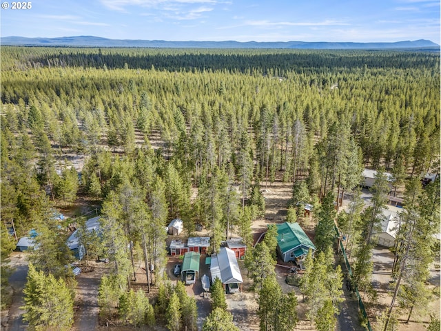 1274 Wild Mustang Ln, Gilchrist, OR 97737 - aerial view of a heavily wooded area and a mountainous background