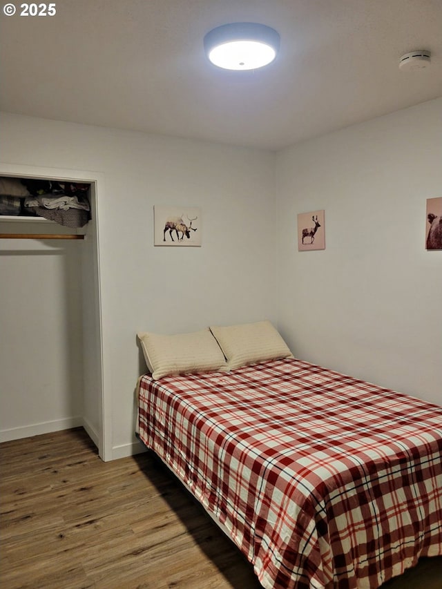 24120 E Farragut St, Welches, OR 97067 - bedroom with wood finished floors, a closet, and baseboards
