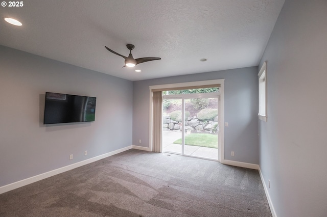 unfurnished room with ceiling fan, carpet, and a textured ceiling