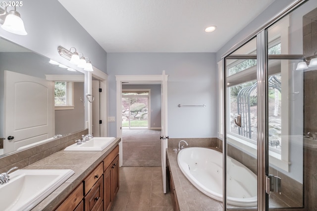 bathroom featuring tile patterned floors, vanity, and shower with separate bathtub