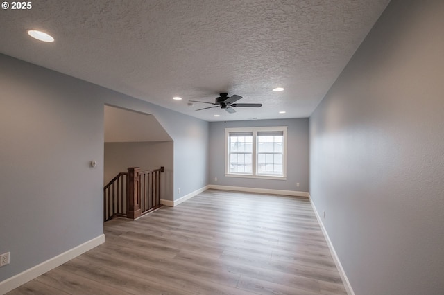 bonus room featuring ceiling fan, a textured ceiling, and light wood-type flooring