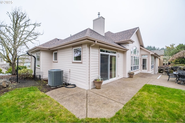 back of property with a yard, a patio area, and central air condition unit