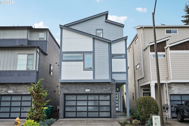 14410 SW Aiken Ln, Beaverton, OR 97005 - contemporary home featuring a garage, driveway, and brick siding