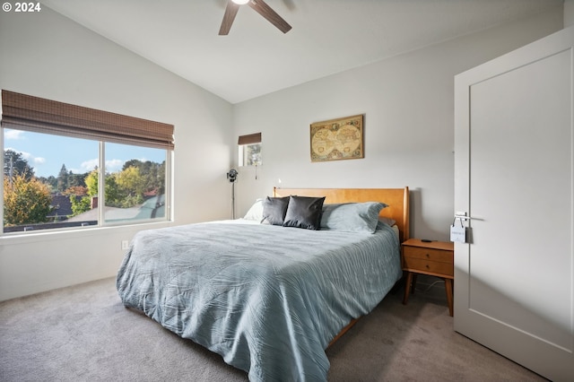 carpeted bedroom featuring vaulted ceiling and ceiling fan