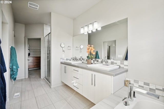 bathroom with tasteful backsplash, vanity, and independent shower and bath