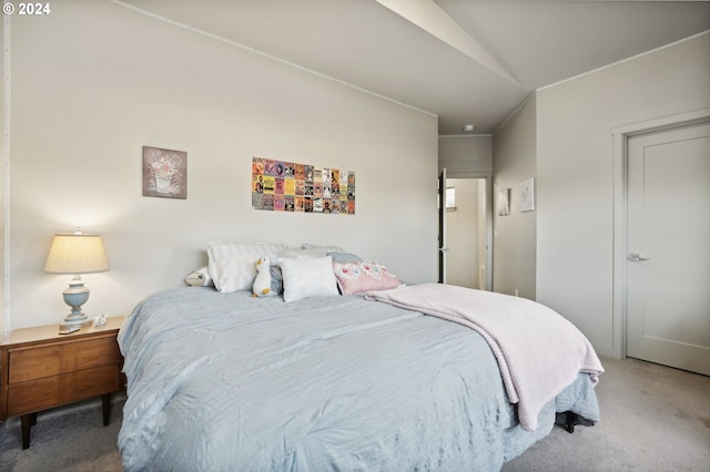 carpeted bedroom featuring vaulted ceiling