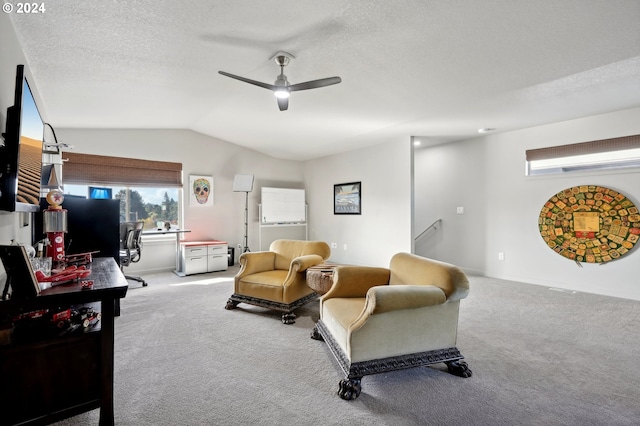 living room featuring vaulted ceiling, a healthy amount of sunlight, light carpet, and a textured ceiling