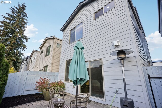 view of side of home with a patio area