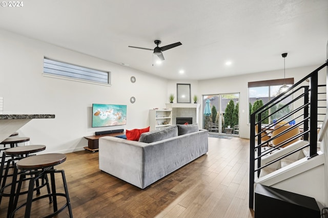 living room with ceiling fan and dark hardwood / wood-style flooring