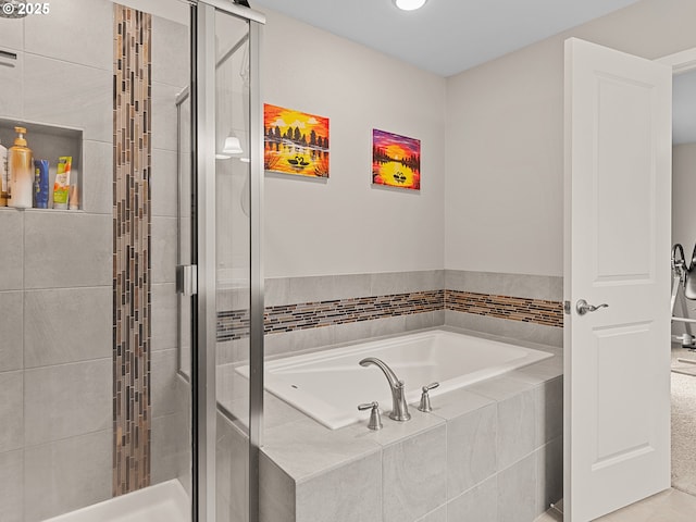 bathroom featuring separate shower and tub