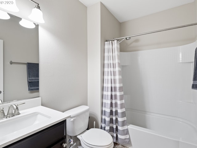 full bathroom featuring vanity, shower / tub combo, and toilet