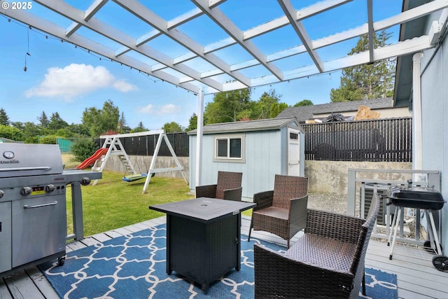 1208 SE Chapman Ave, Troutdale, OR 97060 - deck featuring area for grilling, a storage shed, a fenced backyard, and a playground