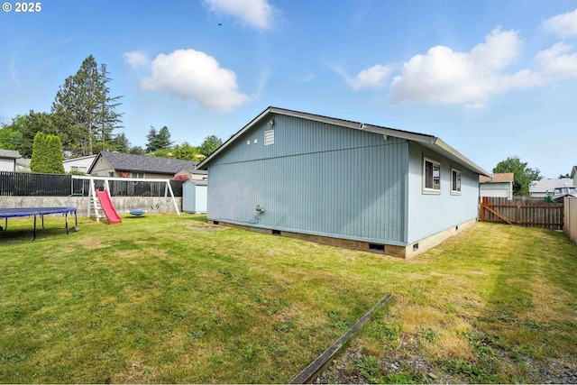 1208 SE Chapman Ave, Troutdale, OR 97060 - view of side of property featuring crawl space, a trampoline, a fenced backyard, a playground, and a storage shed