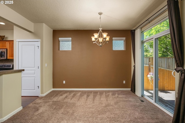 20937 SW Edgemont St, Beaverton, OR 97003 - unfurnished dining area with dark carpet, a chandelier, and baseboards