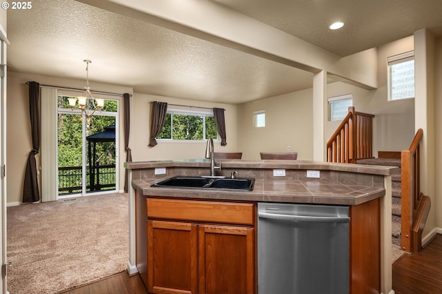 20937 SW Edgemont St, Beaverton, OR 97003 - kitchen featuring dishwasher, a sink, brown cabinets, a textured ceiling, and healthy amount of natural light