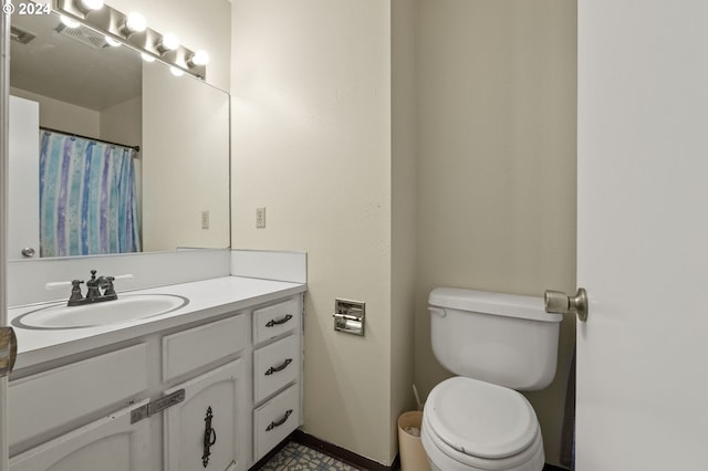 bathroom featuring toilet and vanity