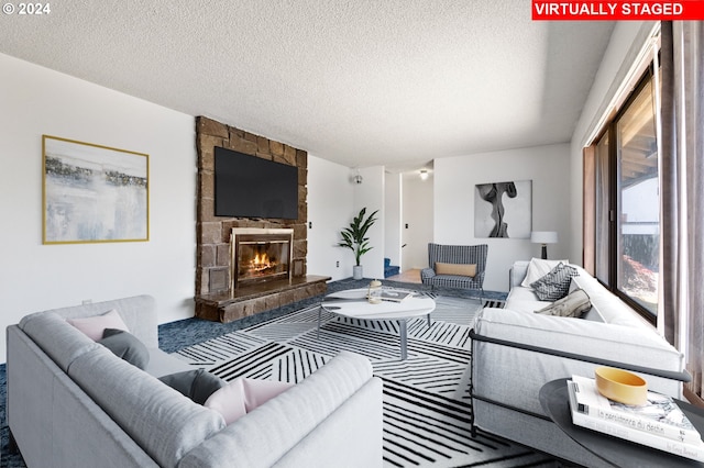 living room with a fireplace and a textured ceiling