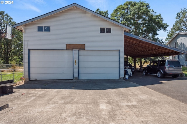 view of side of home with a garage and a carport