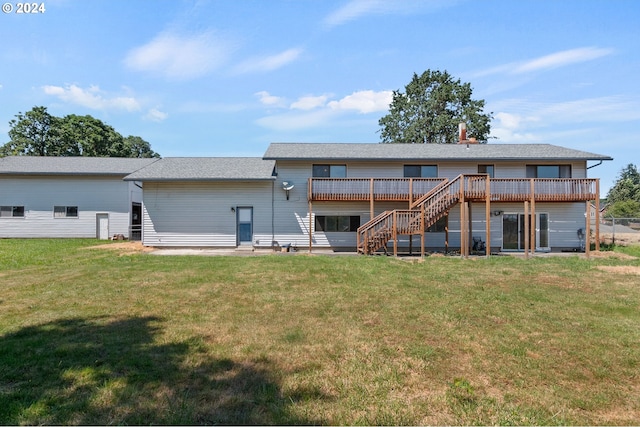 back of property featuring a deck and a yard