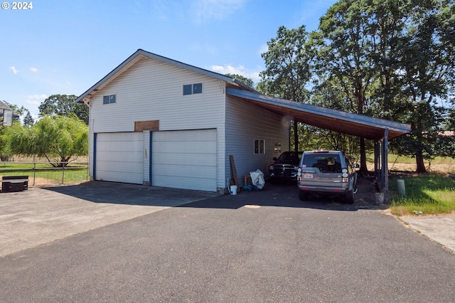 view of side of property with a carport and a garage