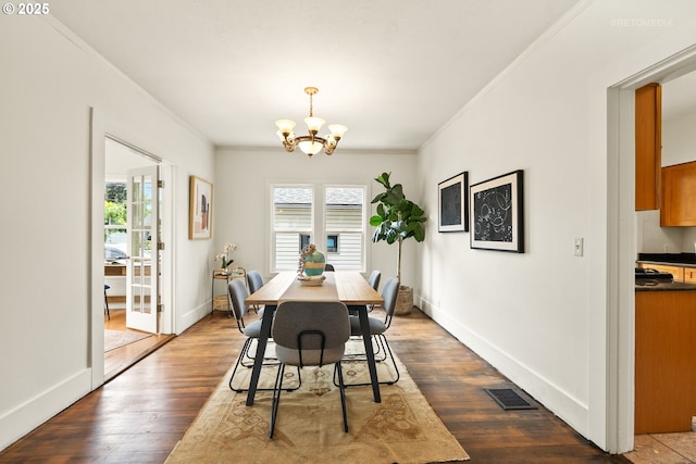 5125 NE Davis St, Portland, OR 97213 - dining space with crown molding, a chandelier, dark wood-style flooring, and baseboards