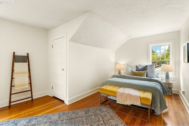5125 NE Davis St, Portland, OR 97213 - bedroom featuring hardwood / wood-style floors, baseboards, and vaulted ceiling