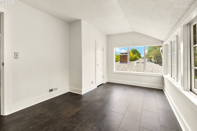 5125 NE Davis St, Portland, OR 97213 - unfurnished room with vaulted ceiling, a textured ceiling, and baseboards