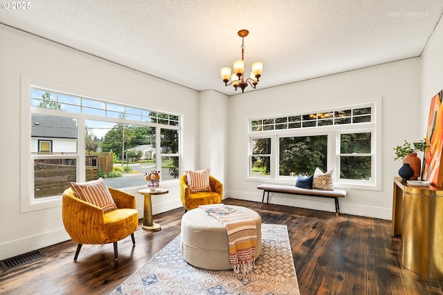 5125 NE Davis St, Portland, OR 97213 - sitting room with a chandelier, dark wood-style flooring, baseboards, and a textured ceiling