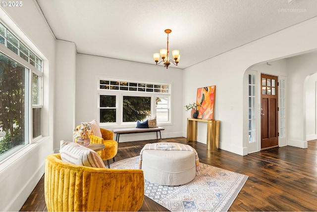 5125 NE Davis St, Portland, OR 97213 - sitting room featuring arched walkways, a chandelier, baseboards, and hardwood / wood-style flooring