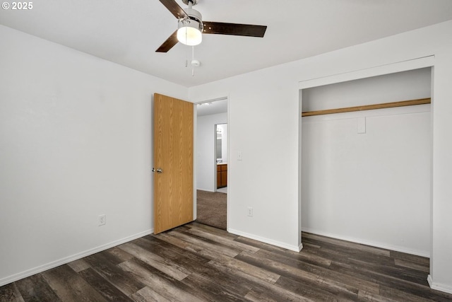 unfurnished bedroom featuring a closet, baseboards, dark wood-type flooring, and ceiling fan