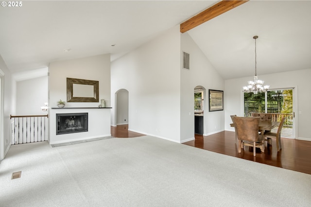 1610 Lee St, Lake Oswego, OR 97034 - unfurnished living room featuring a chandelier, carpet, arched walkways, high vaulted ceiling, and beamed ceiling