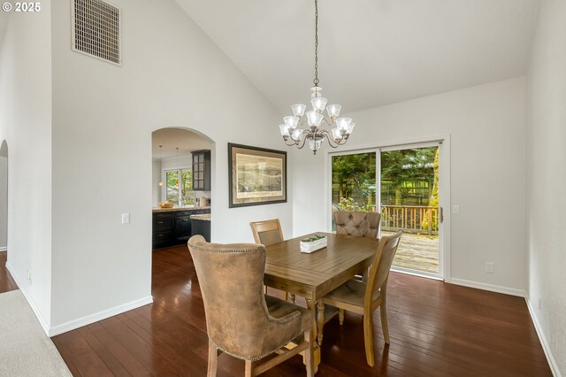 1610 Lee St, Lake Oswego, OR 97034 - dining space with arched walkways, dark wood finished floors, healthy amount of natural light, a chandelier, and high vaulted ceiling