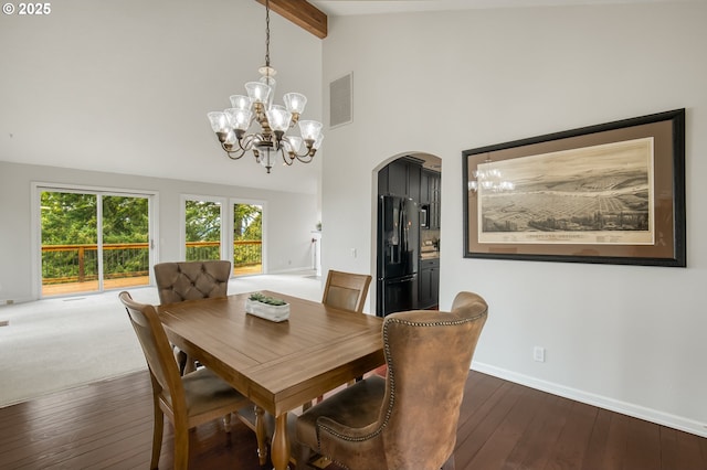 1610 Lee St, Lake Oswego, OR 97034 - dining room featuring arched walkways, a chandelier, beam ceiling, dark wood-style flooring, and baseboards