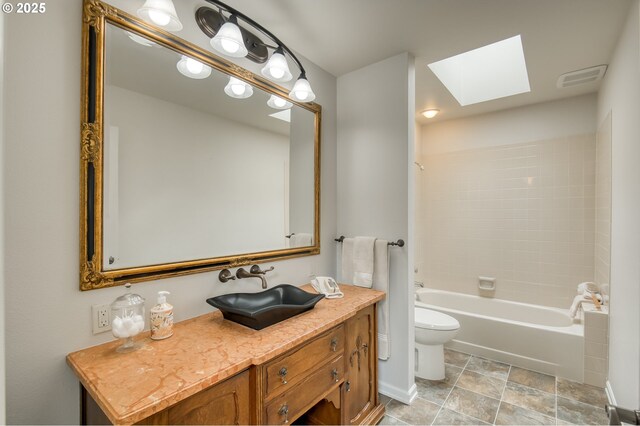 1610 Lee St, Lake Oswego, OR 97034 - bathroom featuring a skylight, toilet, vanity, shower / bathtub combination, and stone finish floors