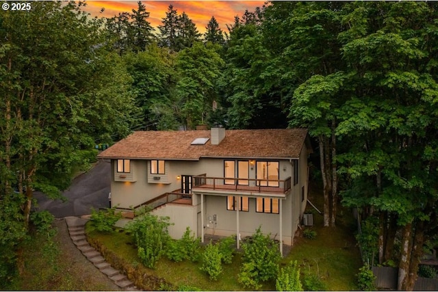 1610 Lee St, Lake Oswego, OR 97034 - rear view of property with a chimney, stucco siding, stairway, central air condition unit, and driveway