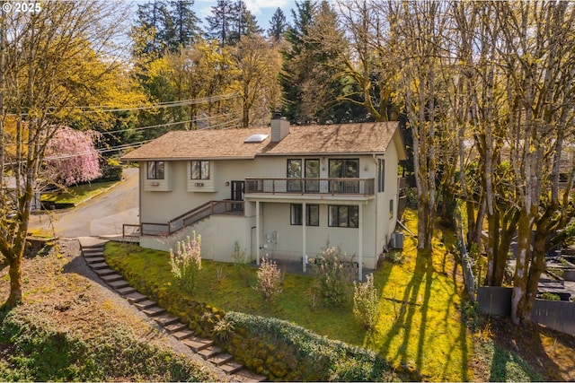 1610 Lee St, Lake Oswego, OR 97034 - back of house featuring a chimney, cooling unit, stairs, driveway, and stucco siding