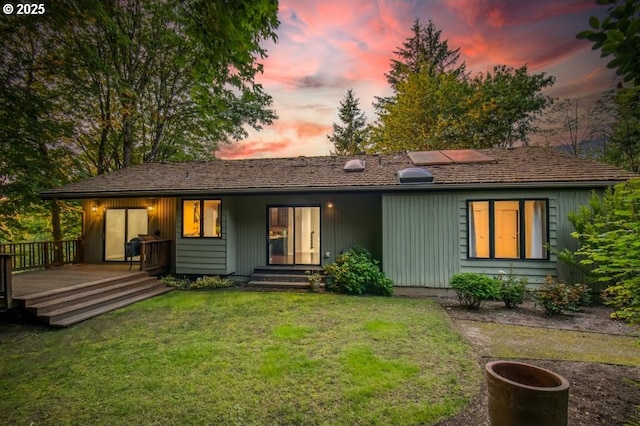 1610 Lee St, Lake Oswego, OR 97034 - back of house at dusk featuring a lawn and a deck