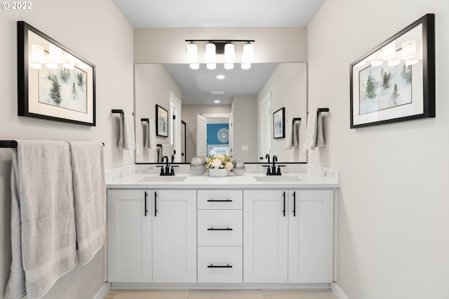 bathroom with a sink and double vanity