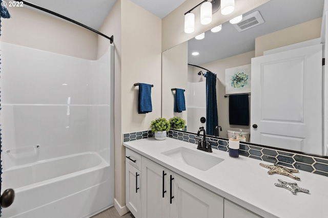 bathroom with vanity, shower / bath combination with curtain, toilet, and visible vents