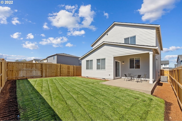 rear view of house with a fenced backyard, a patio, a yard, and central air condition unit