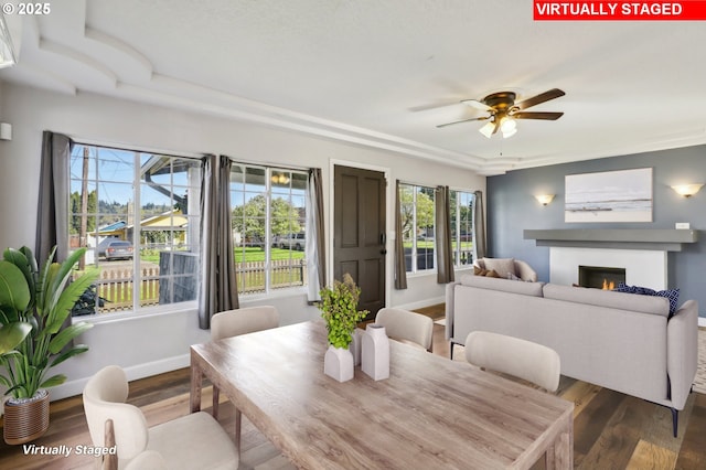 707 S 6th Ave, Kelso, WA 98626 - dining space with baseboards, a ceiling fan, wood finished floors, and a lit fireplace