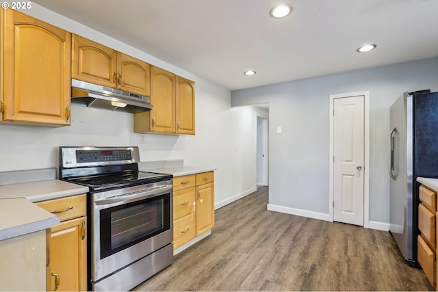 707 S 6th Ave, Kelso, WA 98626 - kitchen featuring recessed lighting, under cabinet range hood, light countertops, appliances with stainless steel finishes, and dark wood-style flooring