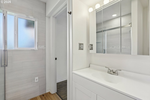 707 S 6th Ave, Kelso, WA 98626 - bathroom with wood finished floors, vanity, a shower with shower door, and plenty of natural light
