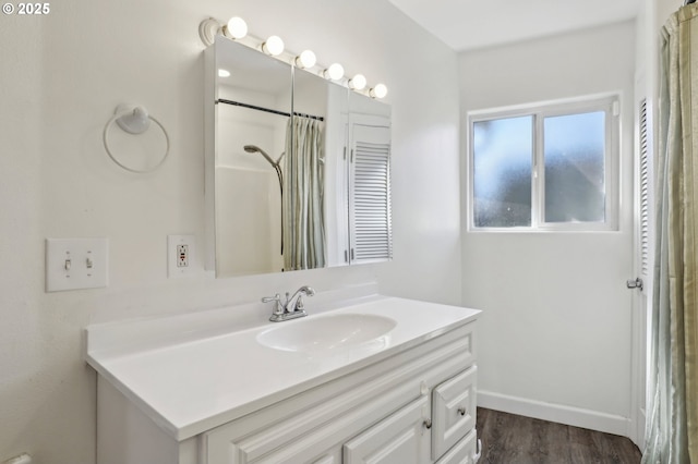 707 S 6th Ave, Kelso, WA 98626 - bathroom with wood finished floors, vanity, and a shower with curtain