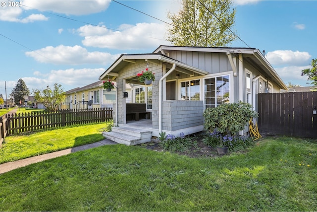 707 S 6th Ave, Kelso, WA 98626 - bungalow with a front lawn, board and batten siding, and a fenced backyard
