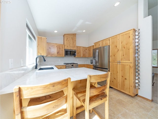 1007 4th Ave, Vernonia, OR 97064 - kitchen with appliances with stainless steel finishes, light brown cabinets, a peninsula, recessed lighting, and a breakfast bar