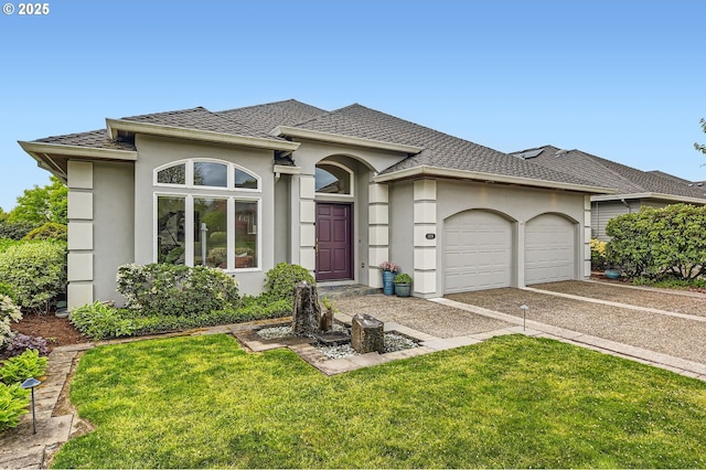 view of front of property with an attached garage, a front lawn, stucco siding, and driveway