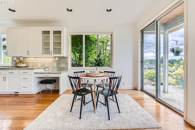 dining area featuring recessed lighting, baseboards, and light wood-type flooring